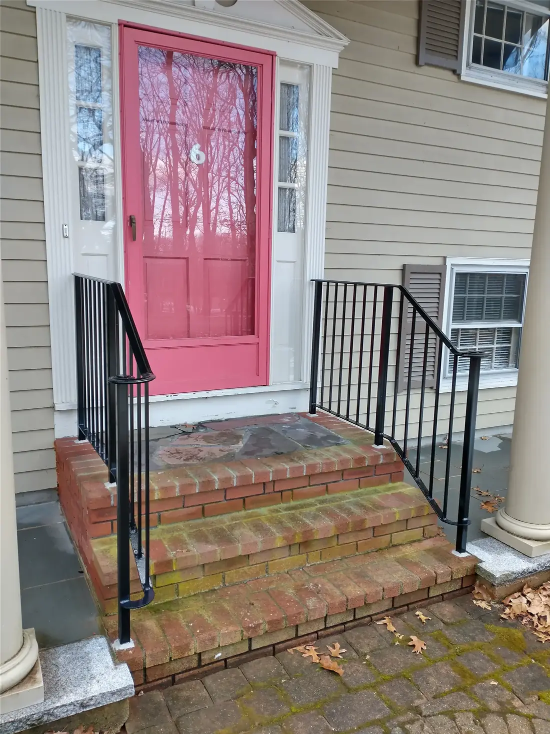 Black iron handrail on front entry steps