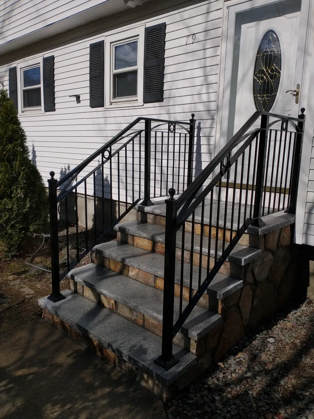 Black steel railing on both sides of stone steps