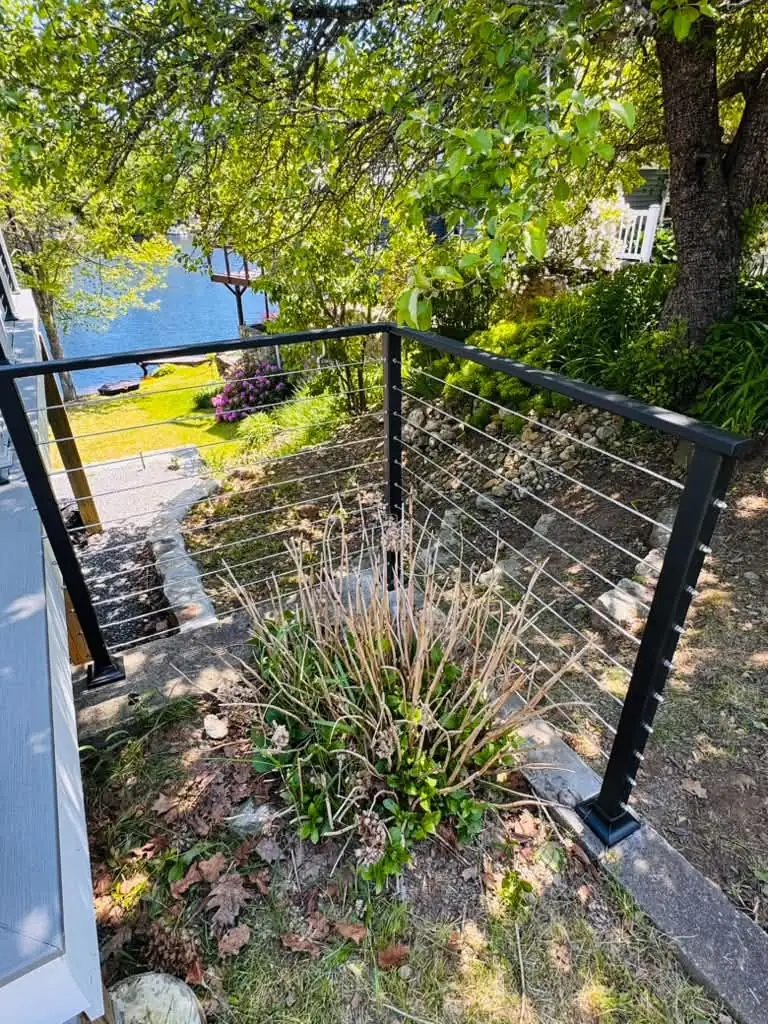 Cable railing on a hillside garden with a lake view