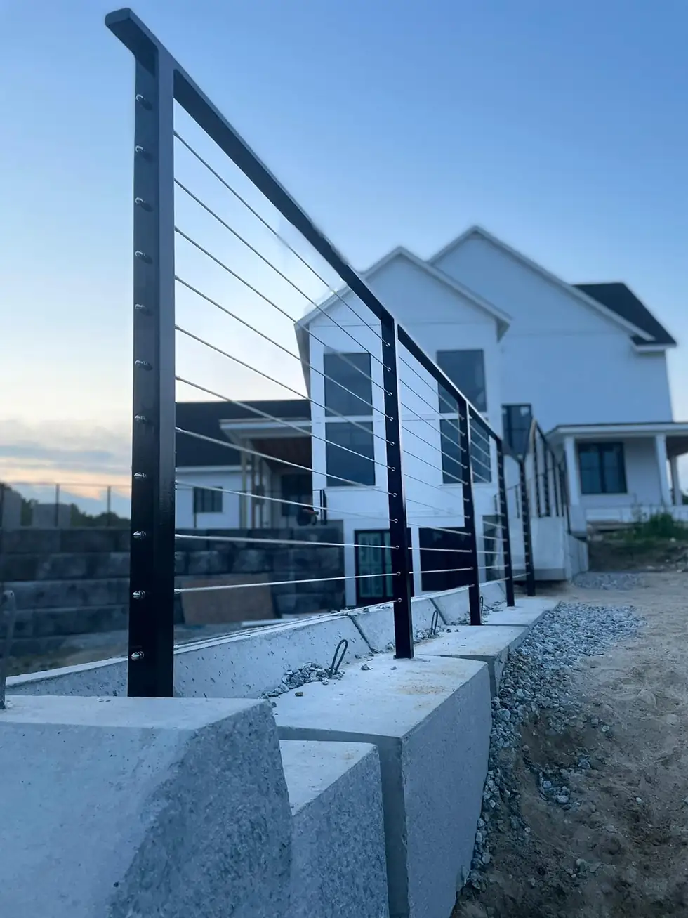 Cable railing installed on a concrete wall during construction