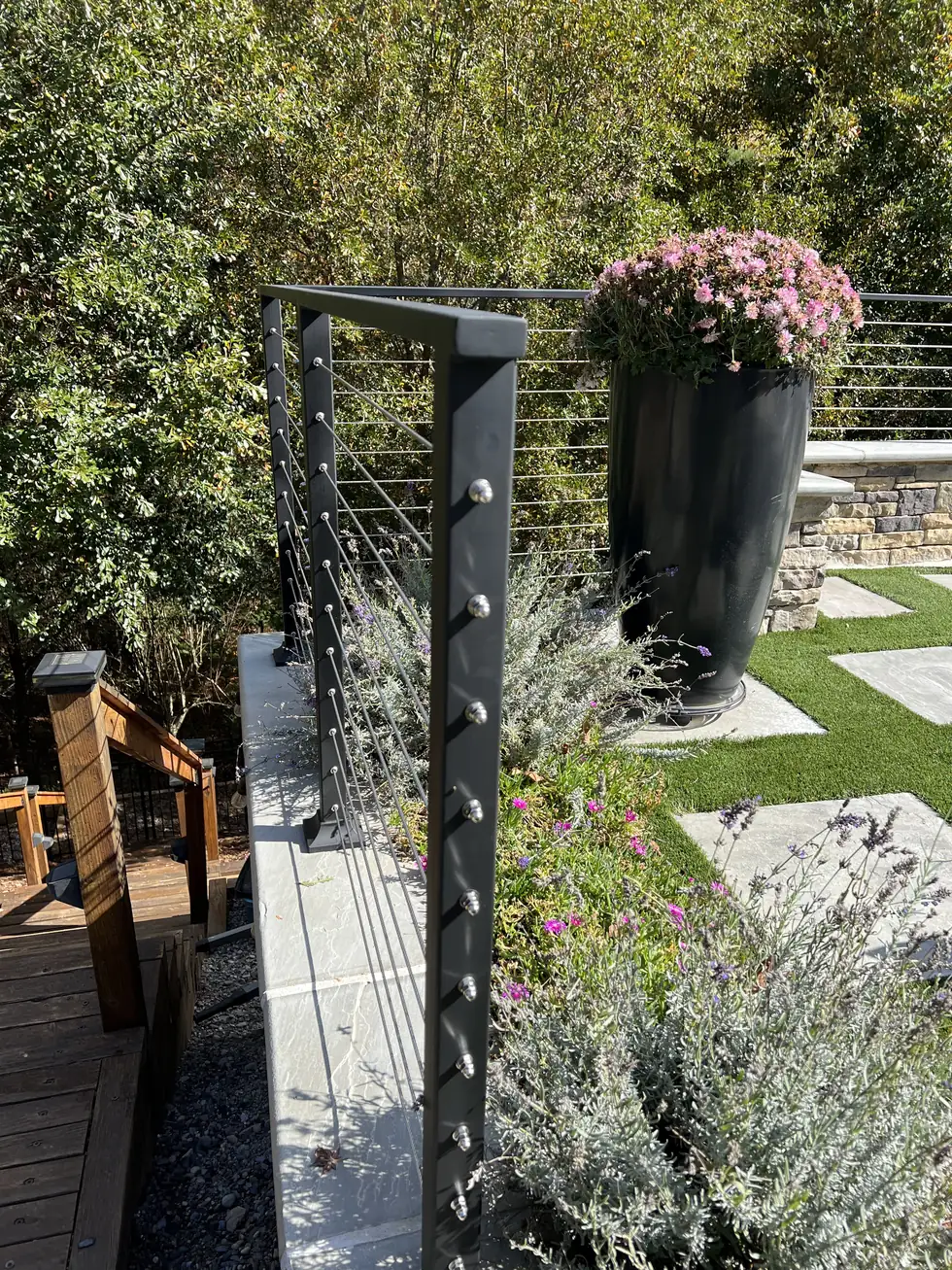 Cable railing post and stainless fittings on a garden patio