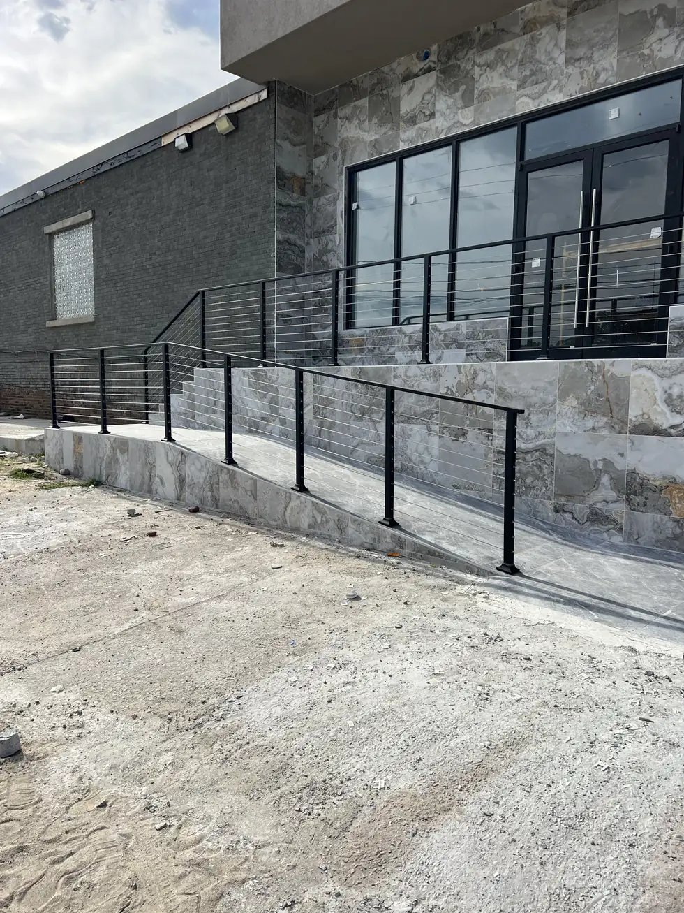 Cable railing on the stone landing of a modern home