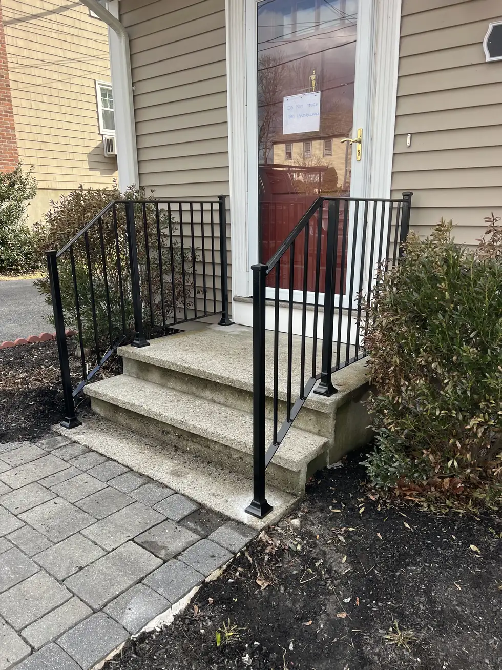 Double black handrail on concrete front steps