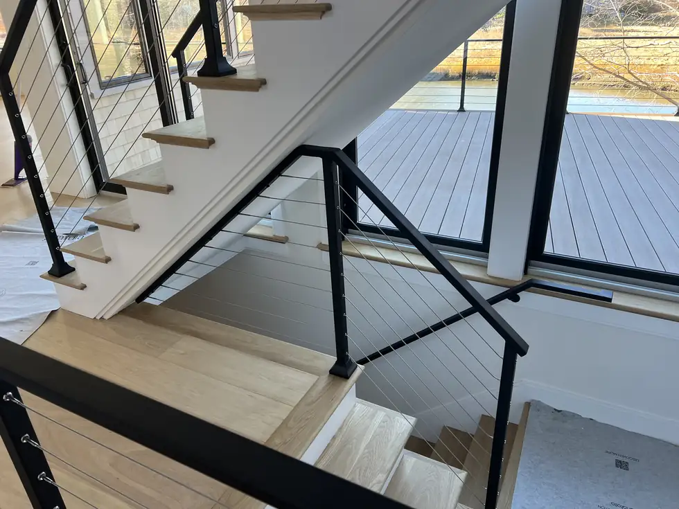 Modern interior cable railing at a stair landing