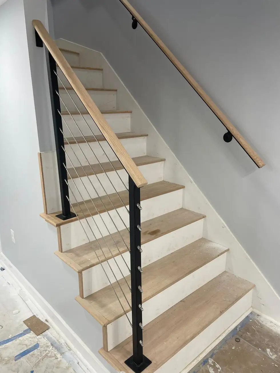 Interior stair cable railing with light oak treads