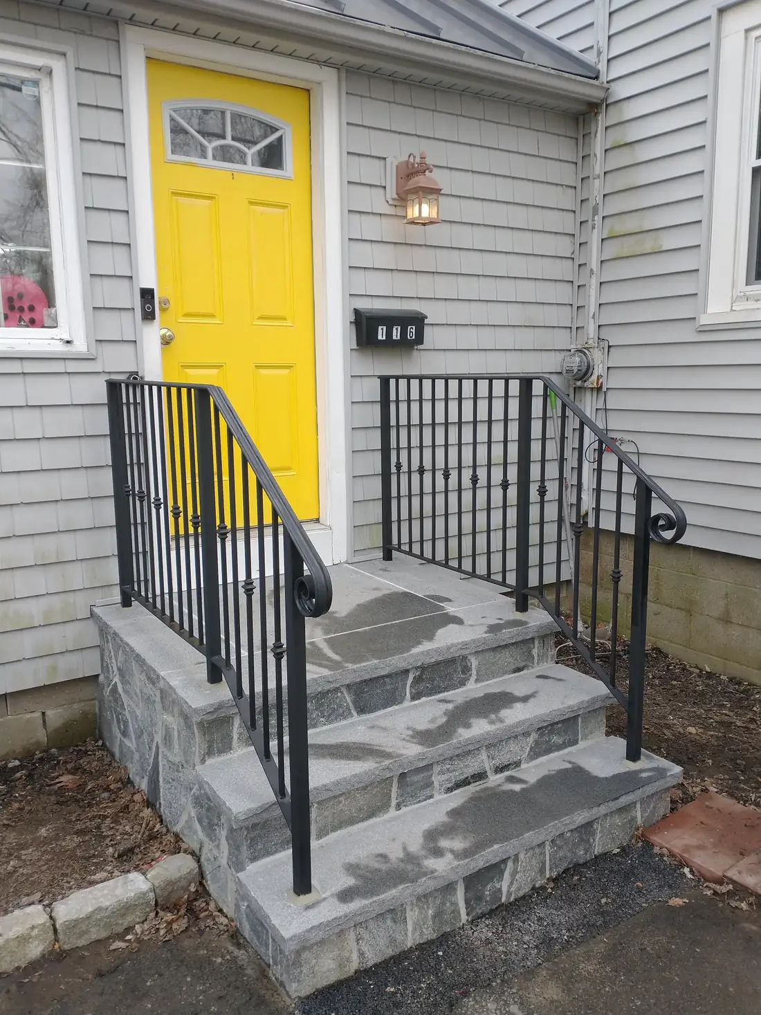 Iron handrail on granite entry steps