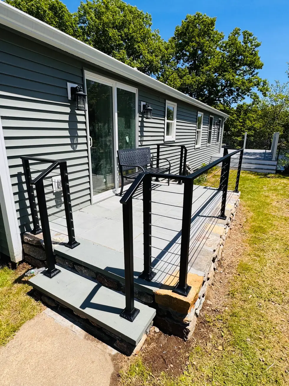Completed cable railing around a lakeside patio and steps