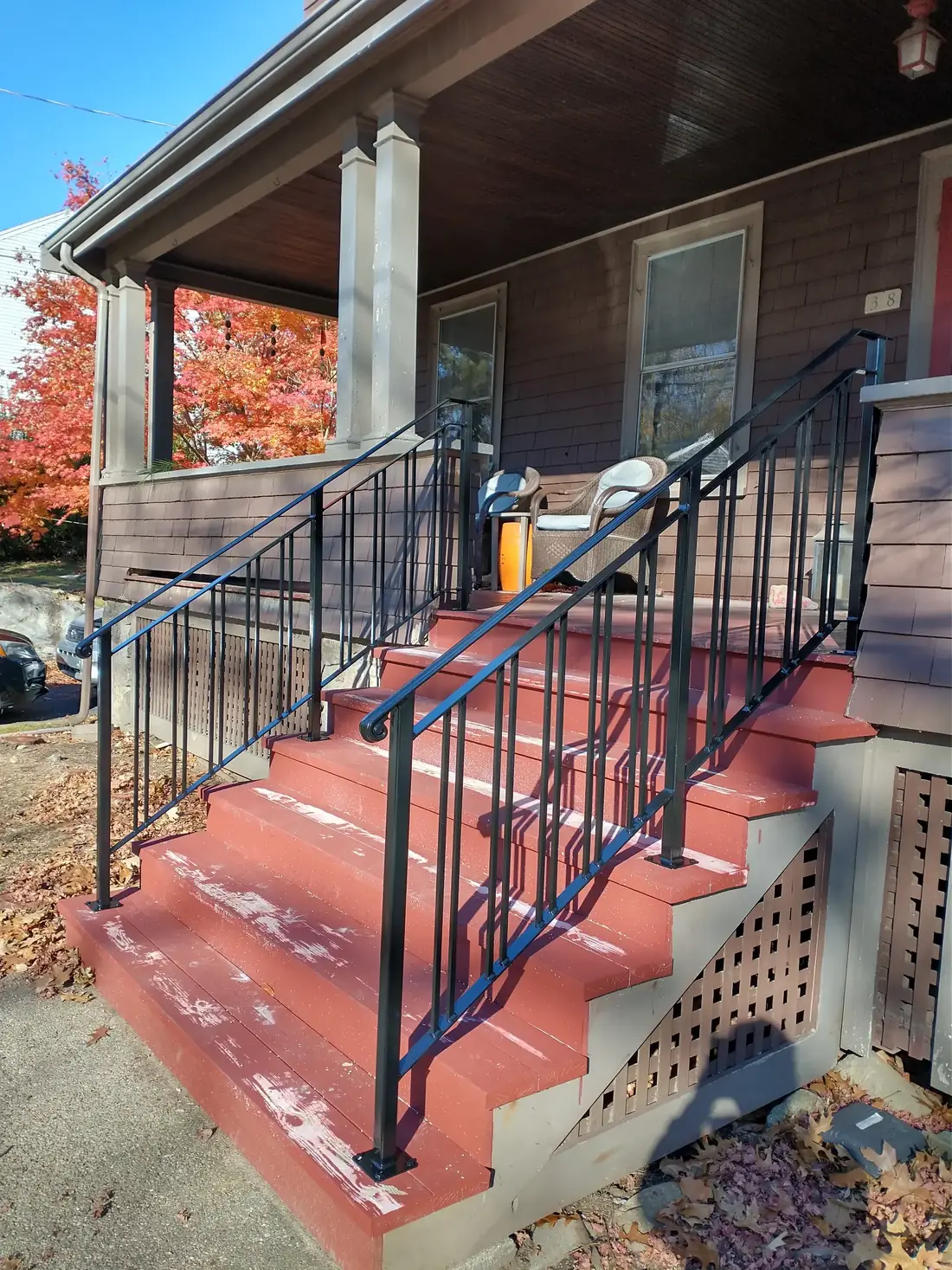 Iron porch railing beside a painted column