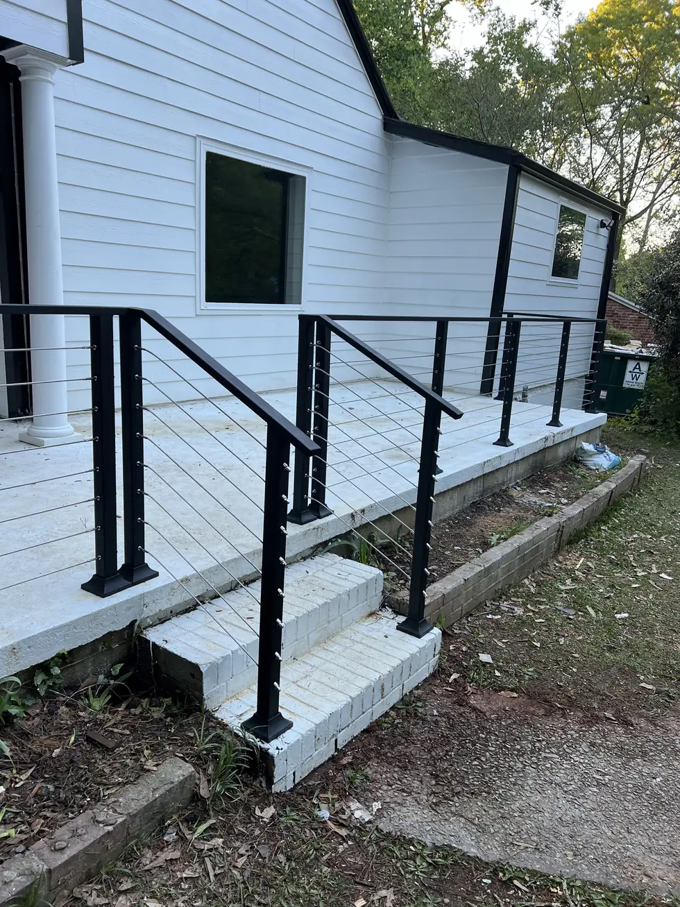 Cable railing on the side entry steps of a white house