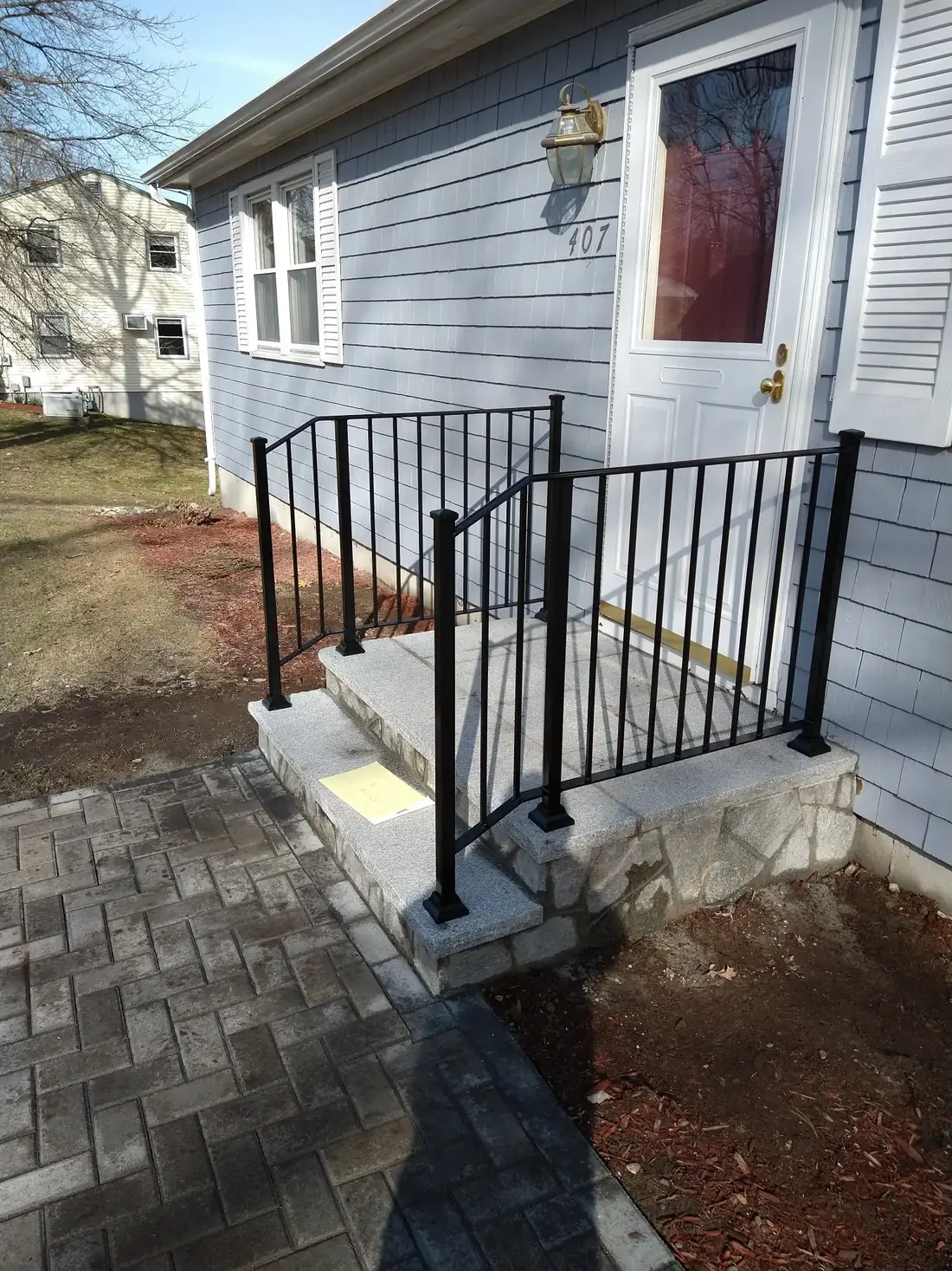 Steel guardrail at a side entry paver landing