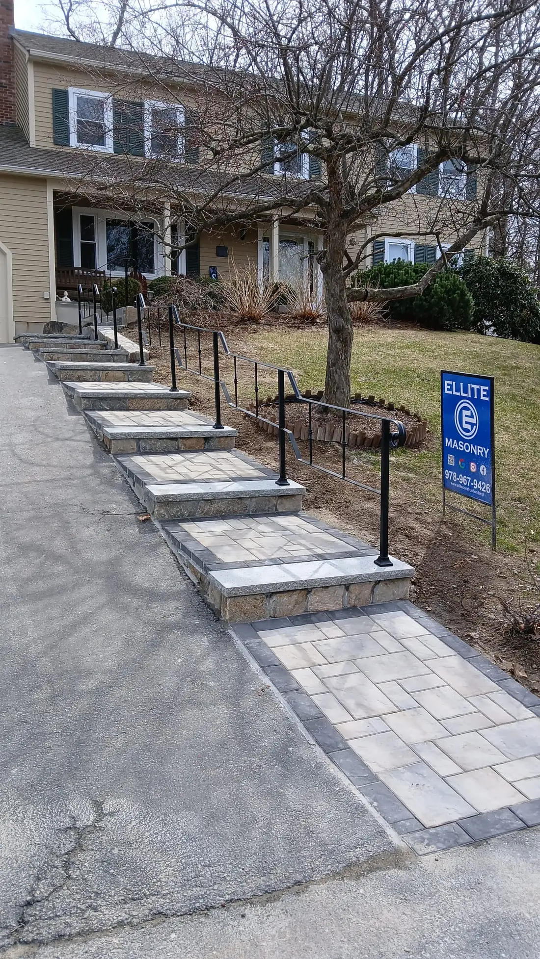 Black steel handrail along a walkway ramp