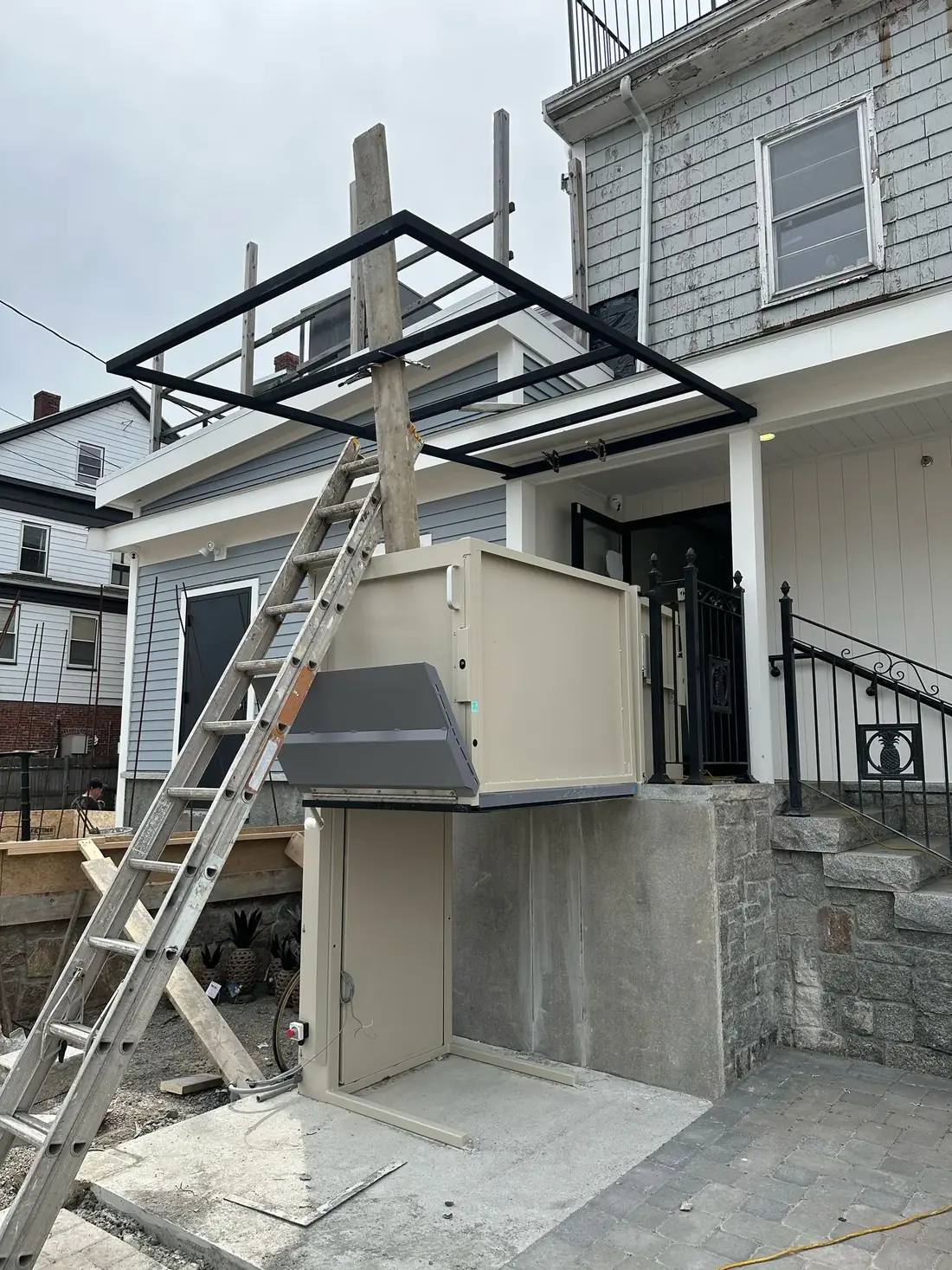 Steel canopy frame installation over a platform lift
