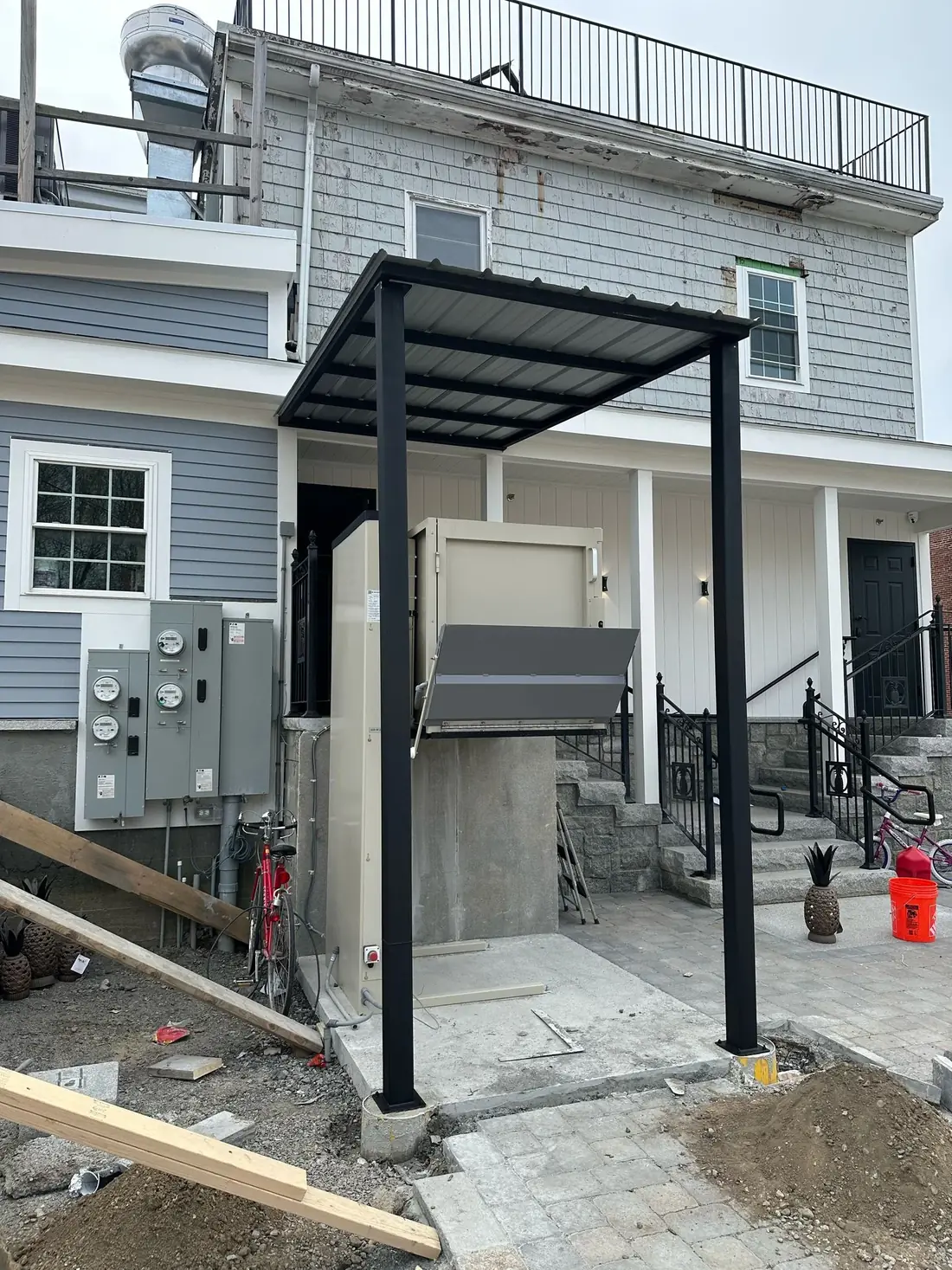 Roof panels installed on a black steel canopy frame