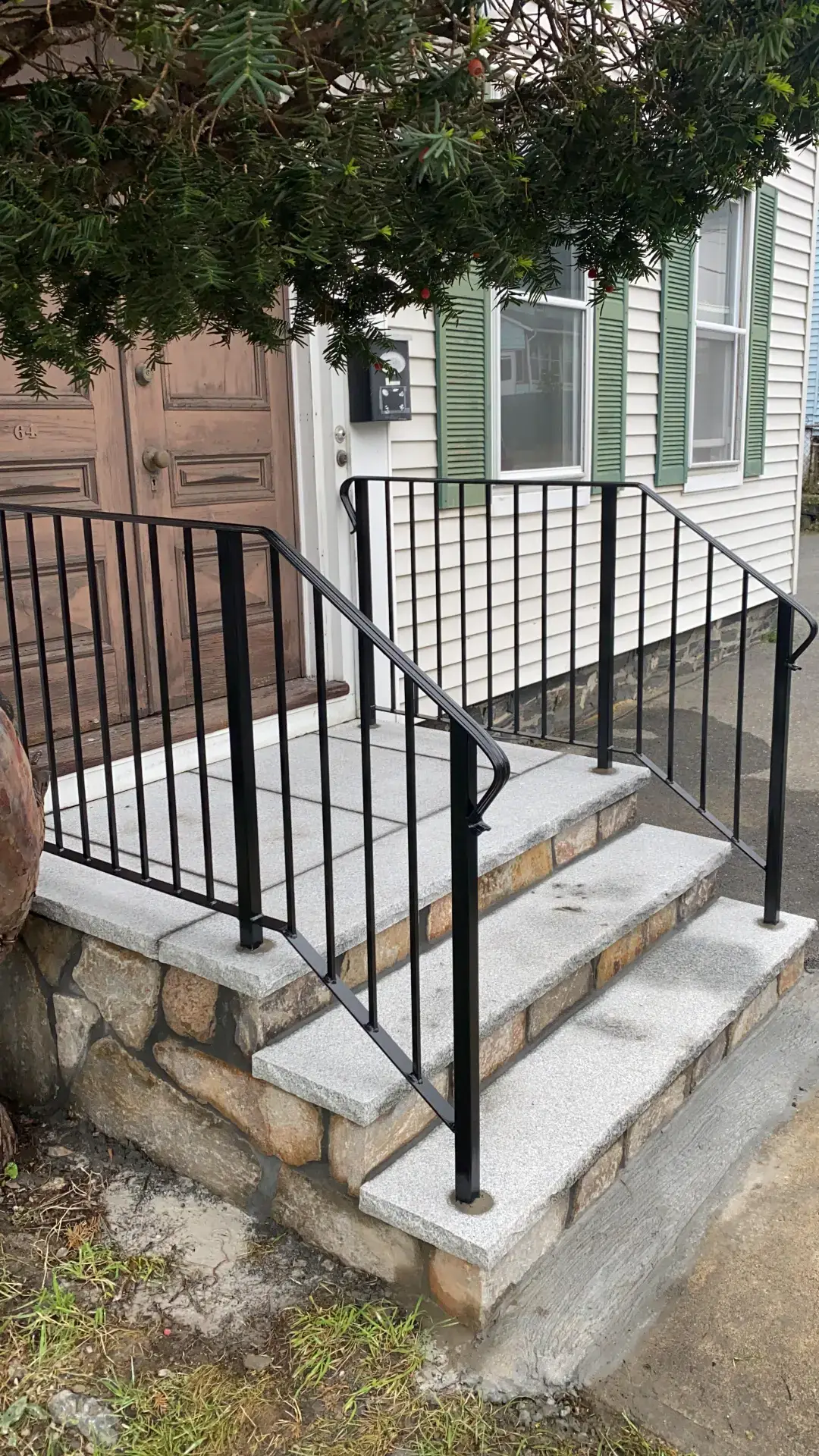 Steel handrail on stone side-yard steps