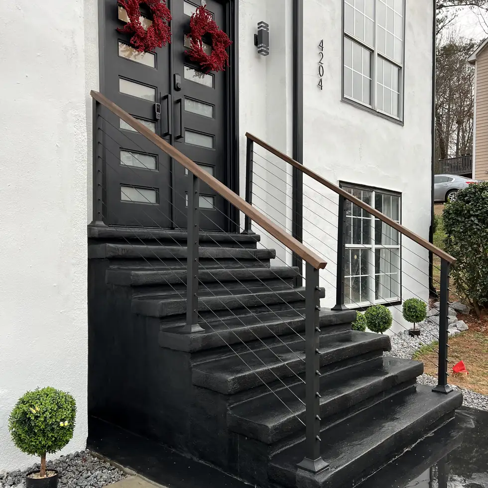 Modern flat bar steel railing with horizontal lines on dark entry stairs