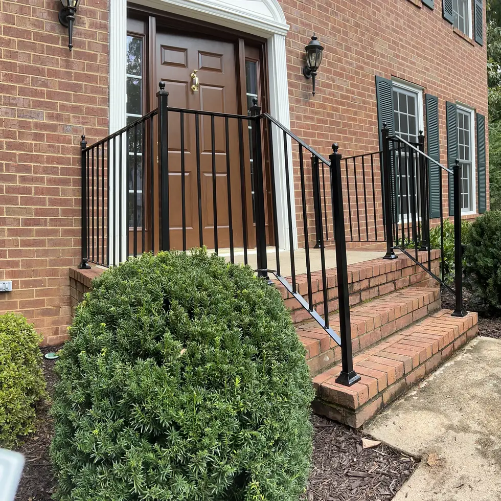 Square tubing railing with vertical pickets on brick entry steps